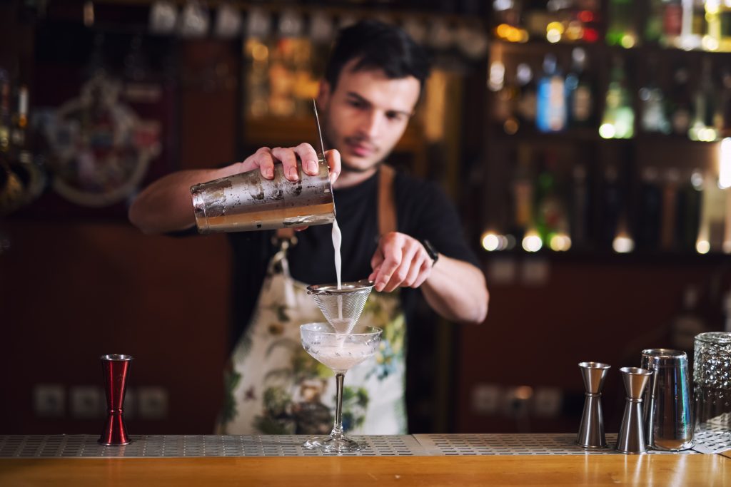 Bartender pouring drink: Bartenders reveal the drinks they secretly hate making