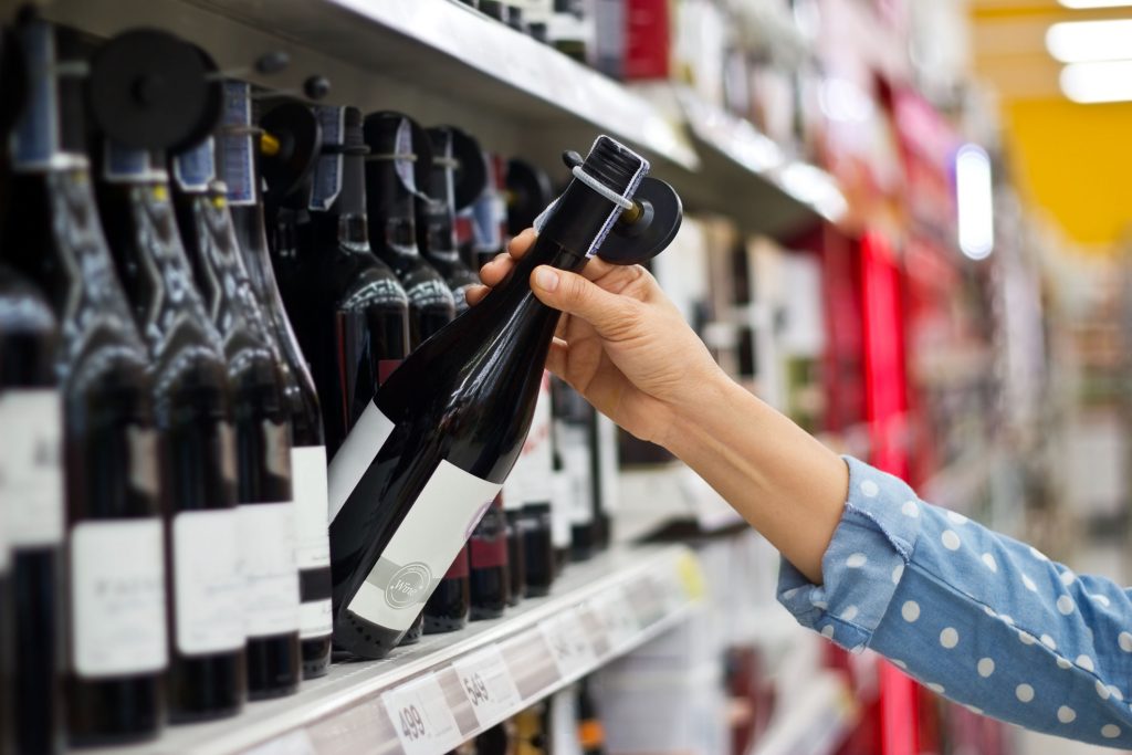 Woman buying wine: global wine consumption falls to lowest levels since 2002