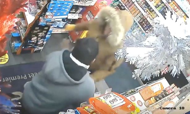 Footage of robber in scuffle with shopkeeper: Shopkeeper fights off burglar with nothing but a wine bottle
