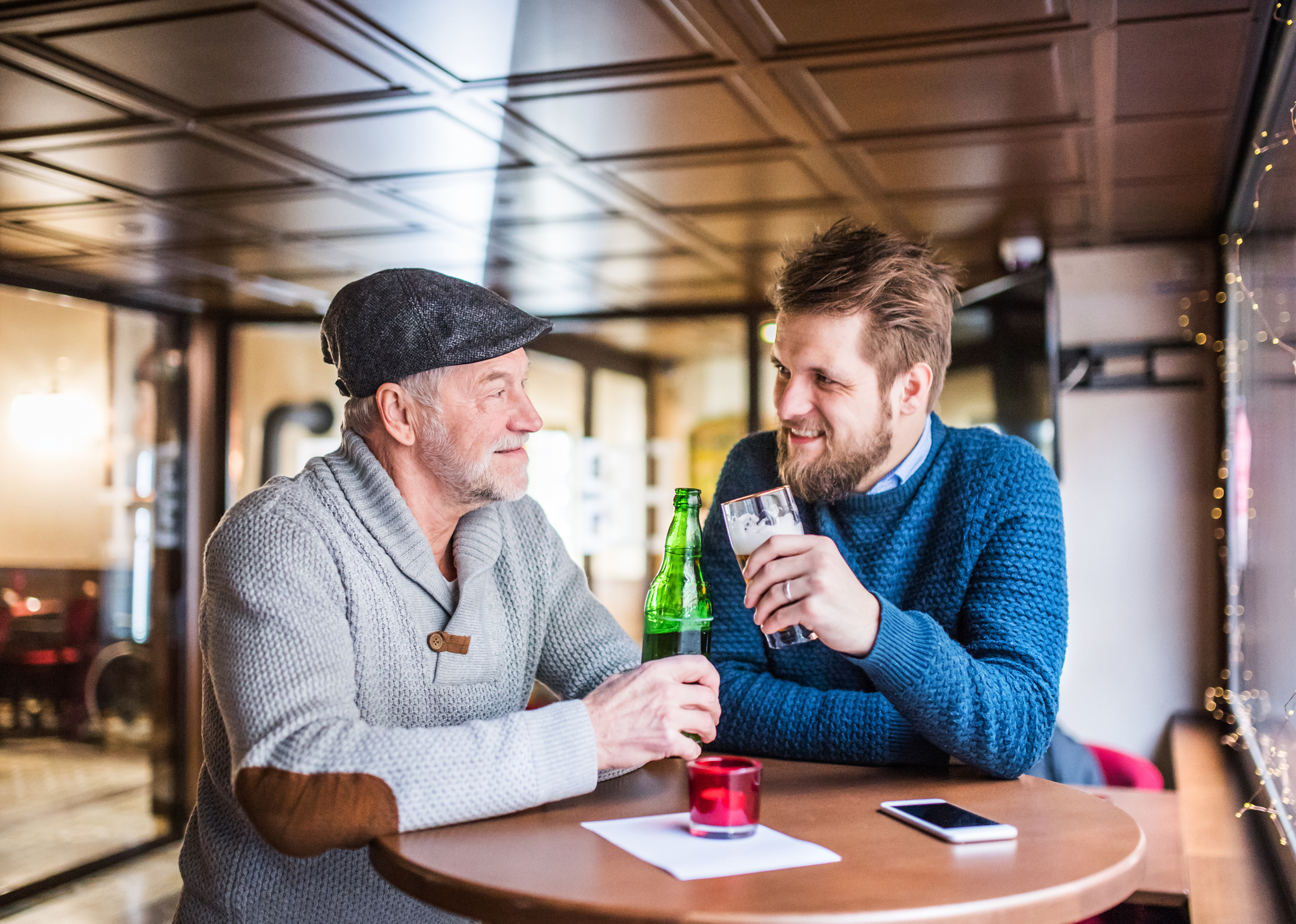 Father and son enjoying a drink: Pubs pledge buy-one-get-one-free drinks in support of mental health charity CALM