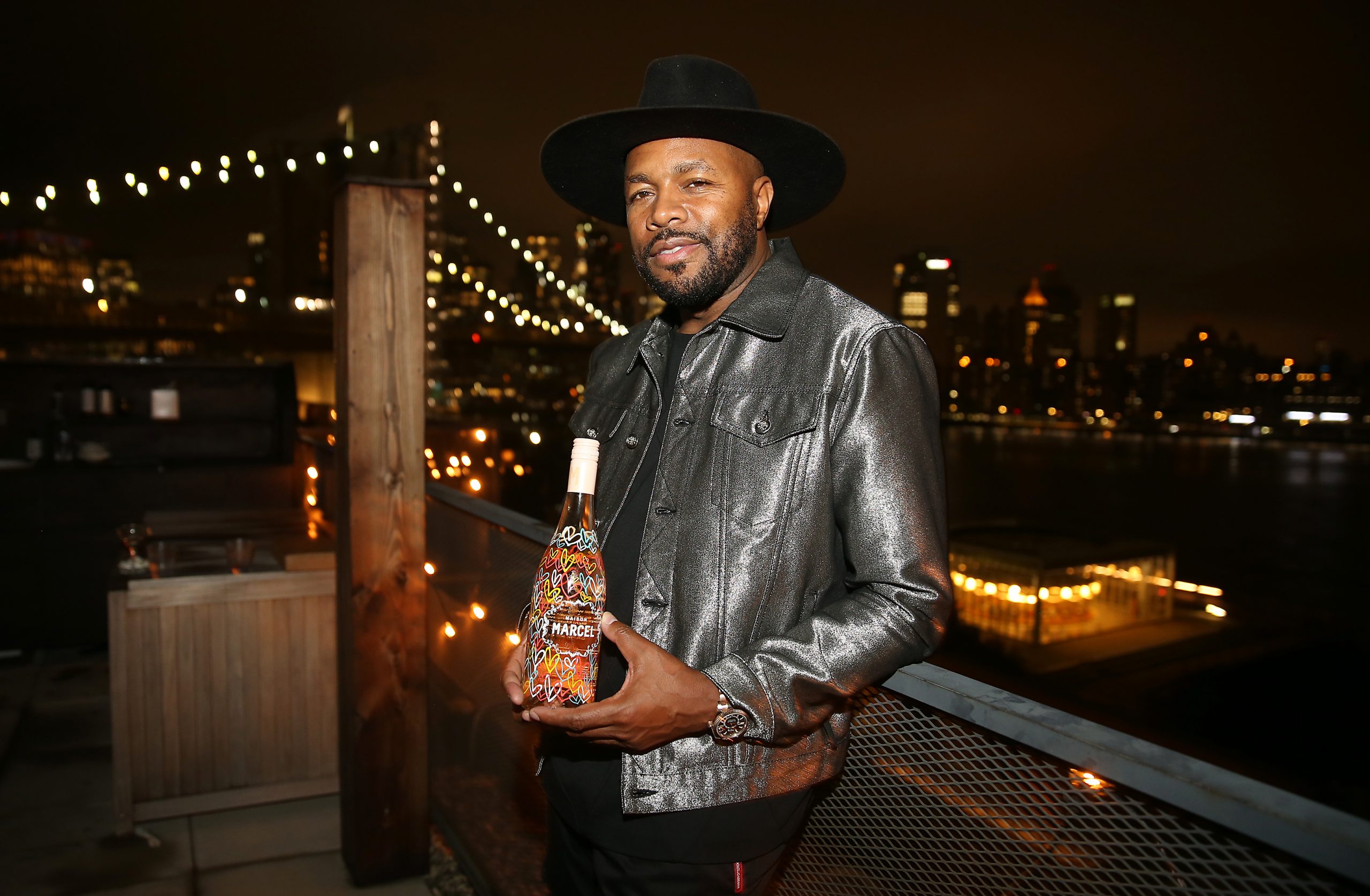 D-Nice holding bottle of Maison Marcel: Rapper and DJ D-Nice invests in French wine label