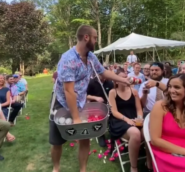 'beer boy' hands out beers at wedding ceremony