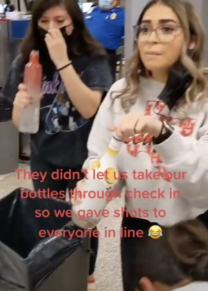 woman gives out shots at airport security