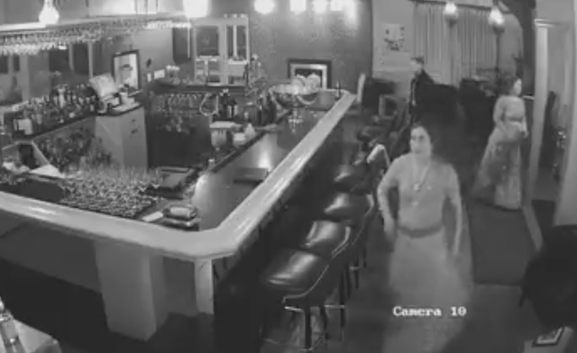 woman stealing cognac from restaurant