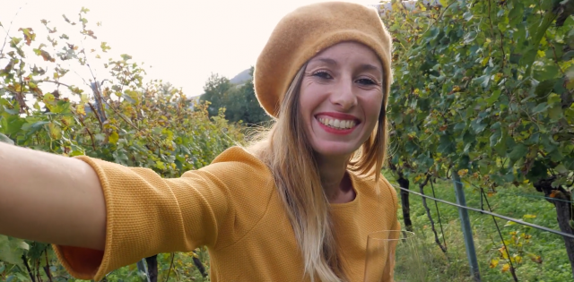 a woman smiling in a vineyard: develop your own wine