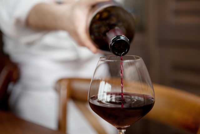 Red wine and stroke - a glass of red wine being poured