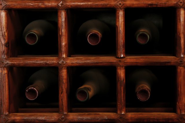 Image of sex wine bottles on their sides in a wine cellar: Man accused of fine wine Ponzi scheme faces extradition to the US