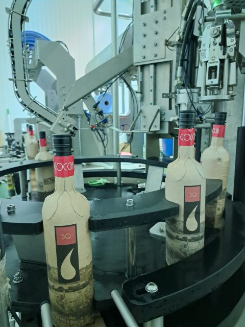 Image of paper wine bottles being filled on a production line: Cantina Goccia launches paper wine bottle filling station