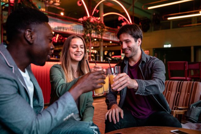 Multi ethnic group of friends meet up in a London pub and having fun together: Soft drinks drive double-digit sales growth for on-trade