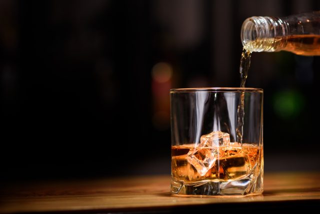 pouring whisky into glass: Premium price tiers drive sales across all US drinks categories, figures show