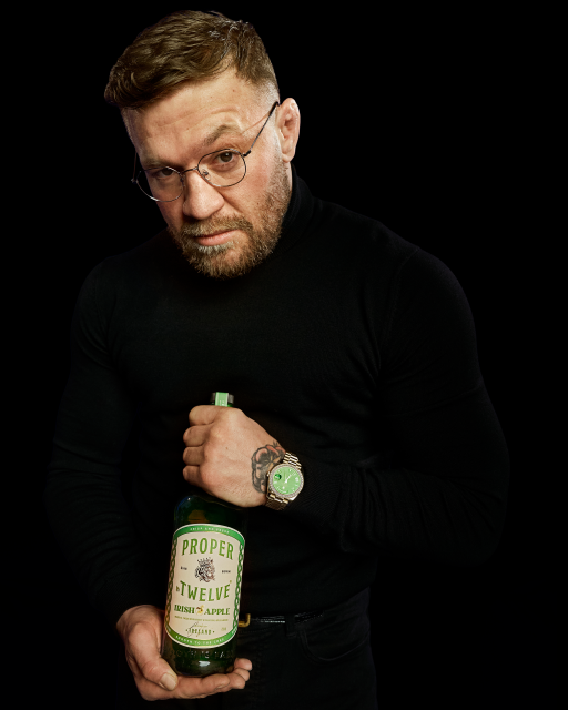 Conor McGregor with a bottle of Proper No. 12 Irish Apple whiskey 