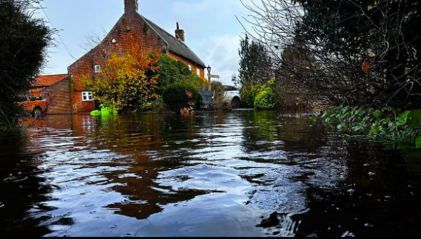 Norfolk pub owner uses canoe in face of floods