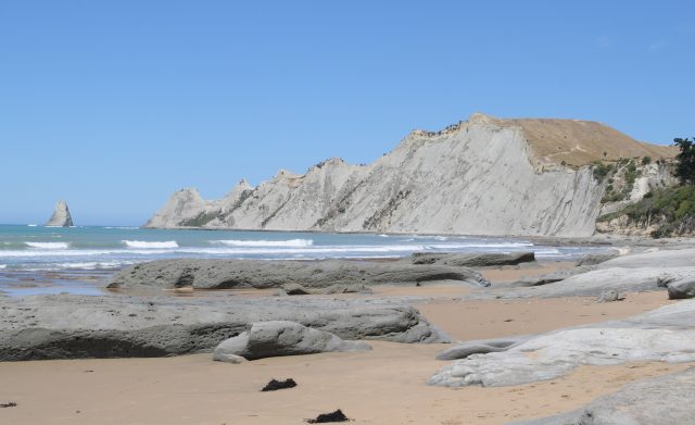 A rugged sandy beach in Hawke's Bay with blue sky