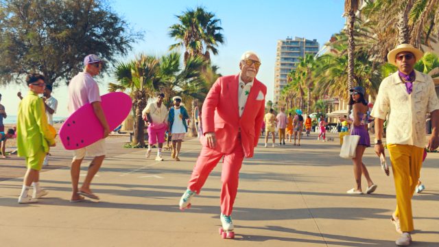 Brian Cox roller skating in a bright pink suit in LA for the Malibu campaign