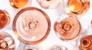 Rose wine glasses set on wine tasting. Different varieties, colors and shades of pink wines on white background. Top view. Rosé may no longer be the booming juggernaut it once was, but its evolution from trend to trusted category reveals a more resilient and refined market. Provence, in particular, is emerging as the new gold standard for pink wine lovers, writes Kathleen Willcox.