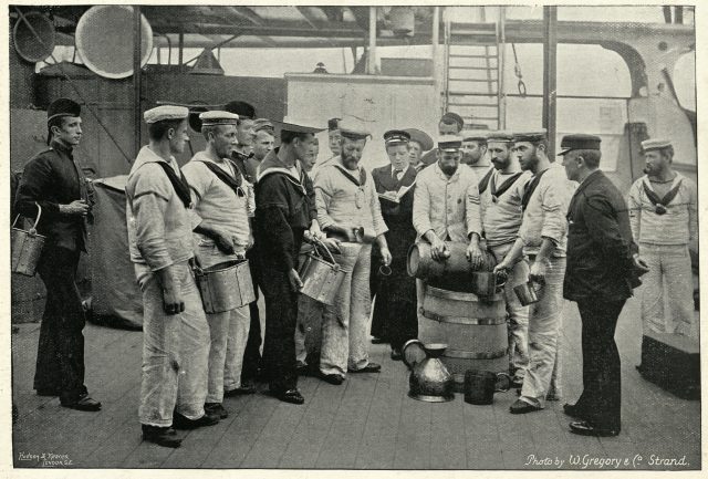 Vintage photograph of Royal navy sailors receving a ration of Grog
