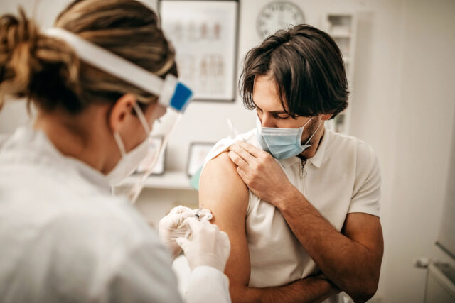 a man gets vaccinated for Covid-19